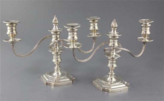 A pair of 1970s silver two branch three light dwarf candelabra, by Barker Ellis Silver Co, weighted.